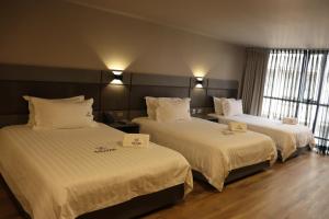 Voodi või voodid majutusasutuse Giluxe Hotel toas