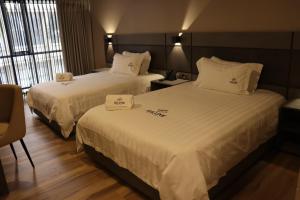 Voodi või voodid majutusasutuse Giluxe Hotel toas