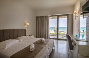 Posteľ alebo postele v izbe v ubytovaní Iperion Beach Hotel