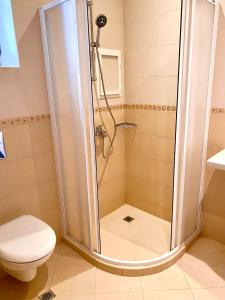 a shower in a bathroom with a toilet at AJ Apartment 2, Santa Marina Holiday Village, Sozopol in Sozopol