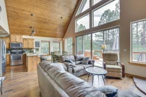 a living room with a couch and a table at Angel Fire Cabin with Deck 3 Mi to Ski Lifts! in Angel Fire