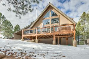 a house with a wrap around deck in the snow at Angel Fire Cabin with Deck 3 Mi to Ski Lifts! in Angel Fire