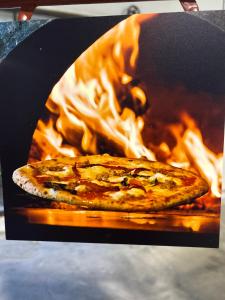 a slice of pizza cooking in a fire oven at B&B Anna Lungomare in Agropoli