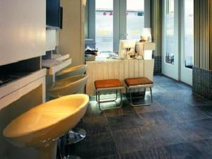 a bathroom with two sinks and two stools at Mingle At The Eden in Hong Kong