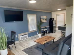 a living room with a couch and a table at Gulf Coast Inn in Gulf Breeze