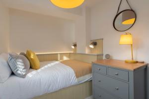 a bedroom with a bed with a dresser and a mirror at Stunning - 2 Bedroom - 2 Bathroom home - Nr Kirkby Lonsdale in Carnforth