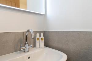 a bathroom sink with two bottles ofodorizers on it at Stunning - 2 Bedroom - 2 Bathroom home - Nr Kirkby Lonsdale in Carnforth +36 photos