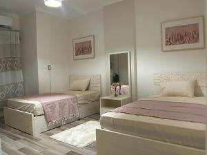 a bedroom with two beds and a mirror at New furnished apartment in Cairo