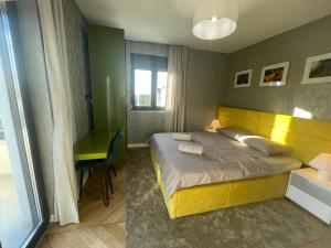 a bedroom with a yellow bed and a desk at Istarska Vila in Poreč +52 photos