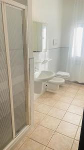 a bathroom with a shower and a sink and a toilet at Appartamento Polpenazze in Polpenazze del Garda