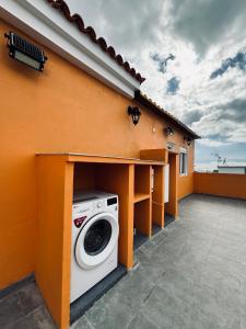 a washing machine under a counter on a house at Avenida 52 B in Los Llanos de Aridane