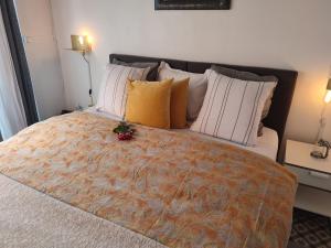 a bedroom with a large bed with a flower on it at Villa Seven Malo in Dunkerque