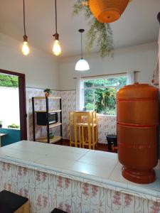 a kitchen with a large white counter in a room at É Hostel - Guesthouse in Ouro Preto