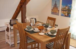 a wooden table with chairs and a dining room at Apartment Traumzeit mit Balkon in Vorstadtvilla in Dresden