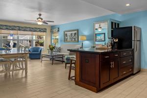 a living room with a kitchen and a dining room at Sun Dek Beach House in Boynton Beach