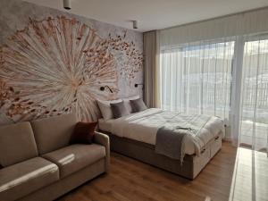 a bedroom with a bed and a couch at Apartament Sunray in Krakow