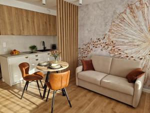 a living room with a couch and a table at Apartament Sunray in Krakow