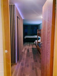 a room with a hallway with a room with a bed at Family Apartment MiniGlück in Sankt Englmar