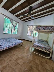 a bedroom with two bunk beds and two windows at Finca la Querendona in Santa Fe de Antioquia +55 photos