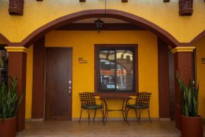 two chairs and a table outside of a building at Estancia 101 in La Paz