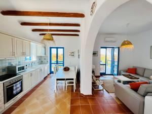 a kitchen and living room with a couch and a table at Paros Home in Kampos Paros