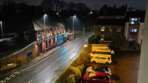 a group of cars parked on a street at night at Homestay by BIC Melbourne 14 - LEEDS in Morley