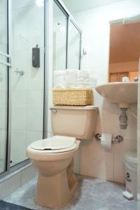 a bathroom with a toilet and a sink at Apto a 2 minutos de Parque la Valvanera in Bogotá