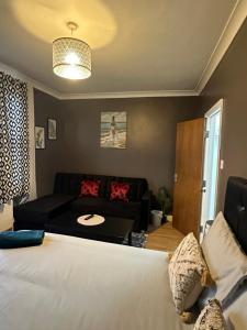 a living room with a bed and a couch at Beautiful Studio Apartment No4 Forest Road in London