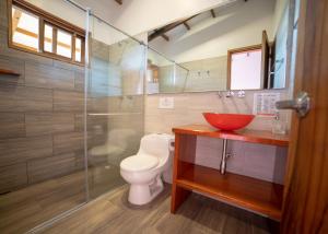 a bathroom with a toilet and a glass shower at Ecoresort Gran Azul in Salento