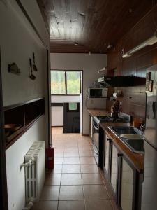 a kitchen with a sink and a stove top oven at Casa centro Bariloche in San Carlos de Bariloche