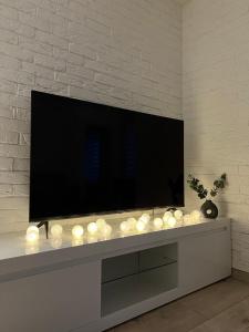 a living room with a television and a bunch of lights at Comfort Apartment In Narva City Center in Narva