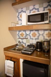 a kitchen with a sink and a microwave at Estancia 101 in La Paz