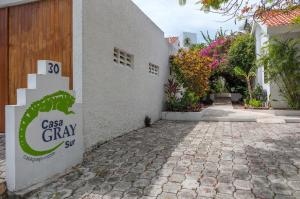 a building with a sign that reads casason clay slip at Beachfront Hammock Heaven in Akumal