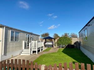 a backyard with a house and a gazebo at Hot tub. Countryside. Coast. 5* Patrington Haven Leisure Park, East Yorkshire in Patrington