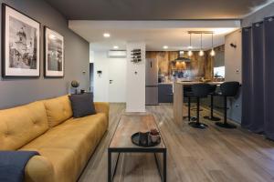 a living room with a couch and a table at SPA Studio apartment SPApartman in Rijeka