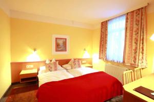 A bed or beds in a room at Hotel Schilcherlandhof