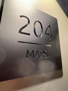 a close up of a sign with the number twenty four mars at Sleephotels Cosmos in Hamburg