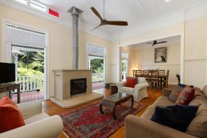 a living room with a fireplace and a couch at Bangalla - luxury hinterland retreat with pool in Coorabell Creek