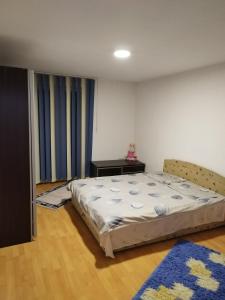 a bedroom with a bed and a table in it at Apartman Leki in Sarajevo