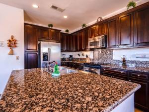 a kitchen with wooden cabinets and a granite counter top at Gorgeous San Felipe Rental Condo in Playa El Paraíso