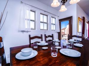 a dining room with a wooden table with dishes on it at Gorgeous San Felipe Rental Condo in Playa El Paraíso
