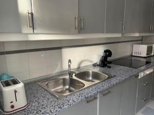 a kitchen with a sink and a counter top at Apartamento Diagonal in Nules