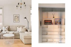 een woonkamer met een bank en een tafel bij Live in historic building - View to Bryggen in Bergen
