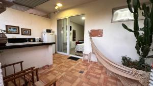 a kitchen with a hammock in a room with a cactus at Pousada Recanto da Estação in São João da Boa Vista