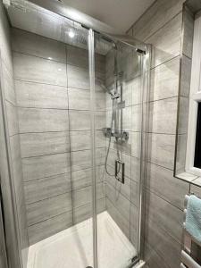 a shower with a glass door in a bathroom at Studio near Heathrow in West Drayton