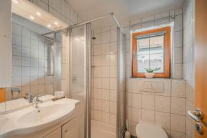 a bathroom with a sink toilet and a shower at Appartement Gamper in Brixen im Thale