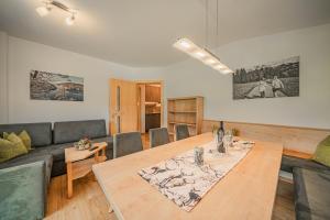 a living room with a table and a couch at Appartement Gamper in Brixen im Thale