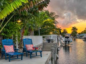 a group of chairs sitting next to a body of water at Captain's Quarters Marathon in Marathon