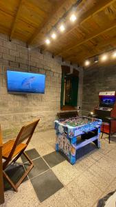a room with a ping pong table and a television at Hotel Boutique Calash in Mar del Plata +31 photos