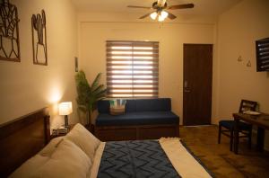 a bedroom with a blue bed and a blue couch at Estancia 102 in La Paz